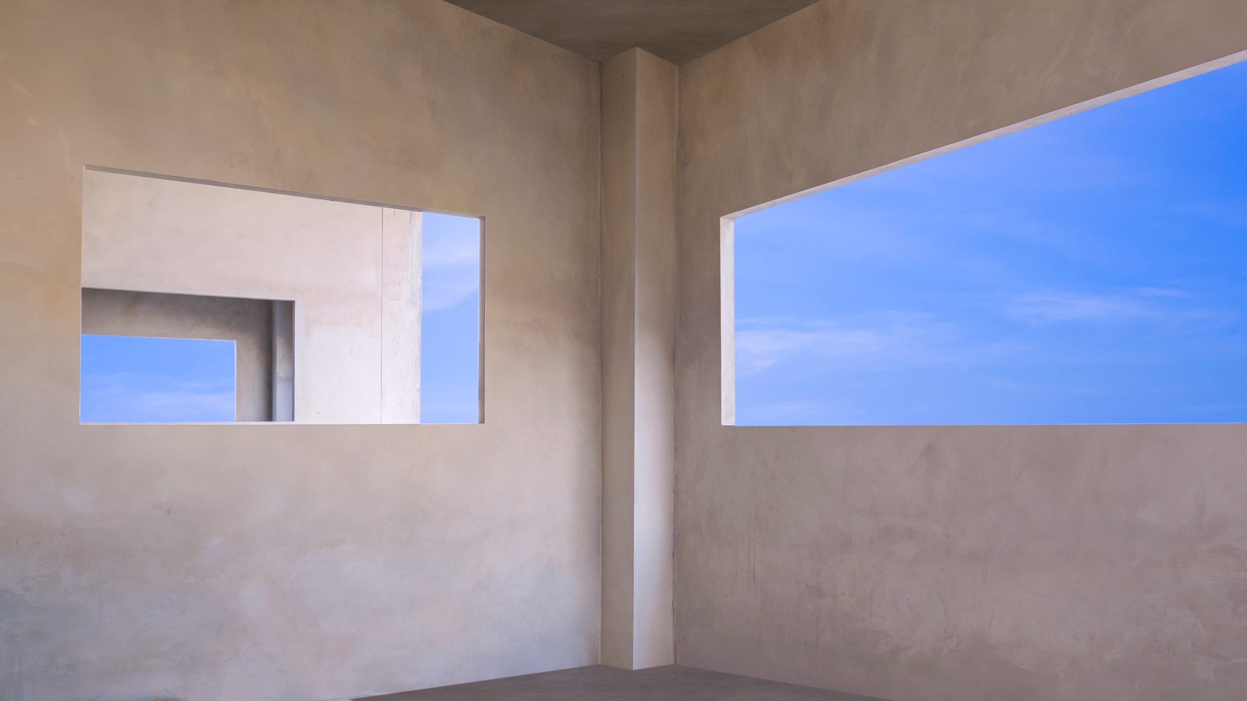 blue-sky-inside-of-windows-frame-on-concrete-wall-2025-03-10-18-53-07-utc