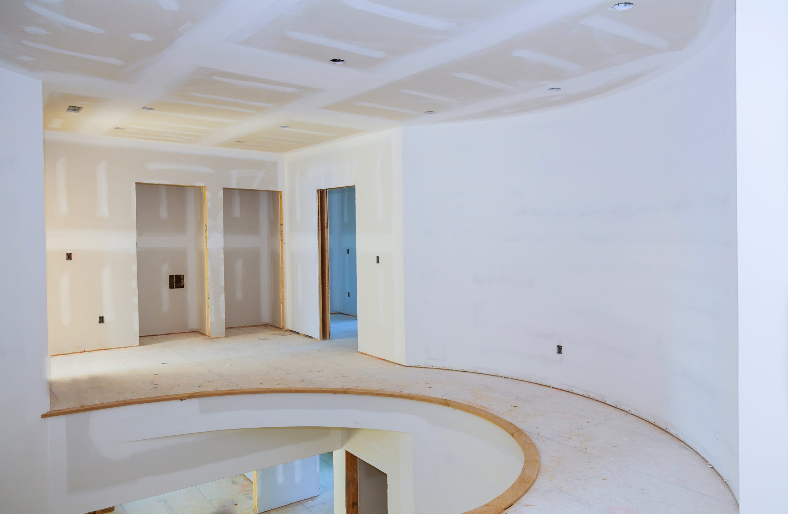 Interior construction of housing project with drywall installed and patched without painting applied